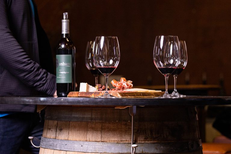 Cabernet bottle with glasses and charcuterie